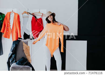 Beautiful young woman trying on shoes in her dressing room 71476116