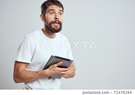 emotional man with tablet in hand touch screen new technologies light background cropped view Copy Space 71476384