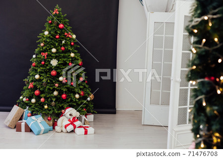 interior of the house with Christmas green Christmas tree decorations and gifts interior of the house with Christmas green Christmas tree decorations and gifts 71476708