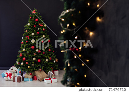 interior of the house with Christmas green Christmas tree decorations and gifts interior of the house with Christmas green Christmas tree decorations and gifts 71476710