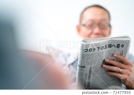 Senior men reading newspaper Senior men reading newspaper 71477950