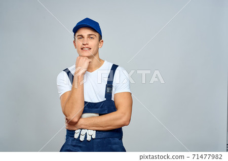 working man in uniform service lifestyle delivery service light background working man in uniform service lifestyle delivery service light background 71477982