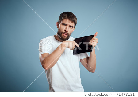 man with tablet near face on blue background cropped view touch monitor new technologies Copy Space 71478151