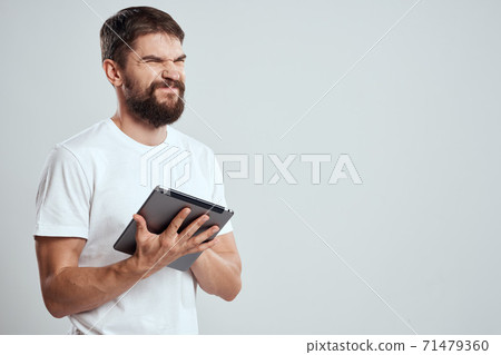 emotional man with tablet in hand touch screen new technologies light background cropped view Copy Space emotional man with tablet in hand touch screen new technologies light background cropped view Copy Space 71479360
