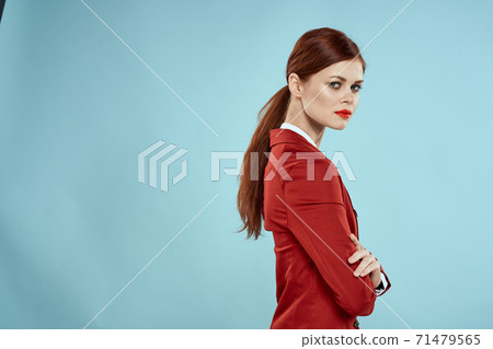Elegant woman in red jacket bright makeup lips self-confidence cropped view blue background 71479565