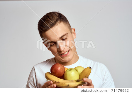 Man with fresh fruit in a cup health lifestyle healthy nutrition vitamins 71479932