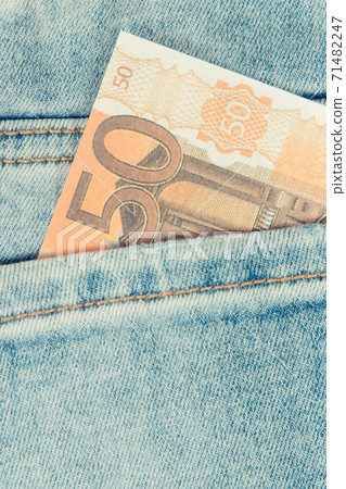 Currencies euro in back blue jeans pocket. Cash payment for shopping concept Currencies euro in back blue jeans pocket. Cash payment for shopping concept 71482247