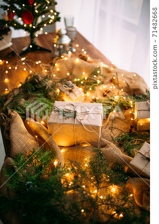 Craft gift box on the wooden table with garland 71482668