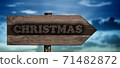christmas sign on wood arrow 71482872