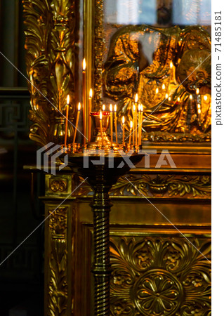 Large church candlestick with burning candles in orthodox church 71485181