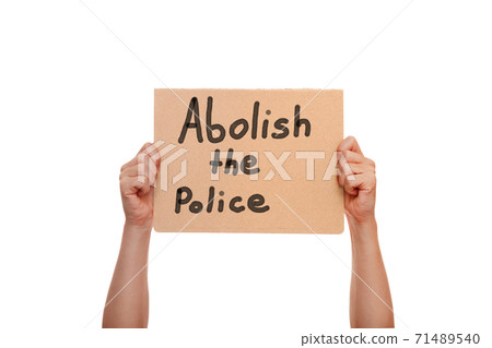 protest hands holding cardboard poster with message text abolish the police isolated on white background, concept on the theme of prostate in minneapolis and police aggression of racism. protest hands holding cardboard poster with message text abolish the police isolated on white background, concept on the theme of prostate in minneapolis and police aggression of racism. 71489540