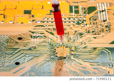 motherboard with contact paths of microcircuit and syringe with needle filled with red liquid, concept on topic of cospirology of vaccination and chipization of society given control to population. motherboard with contact paths of microcircuit and syringe with needle filled with red liquid, concept on topic of cospirology of vaccination and chipization of society given control to population. 71490111