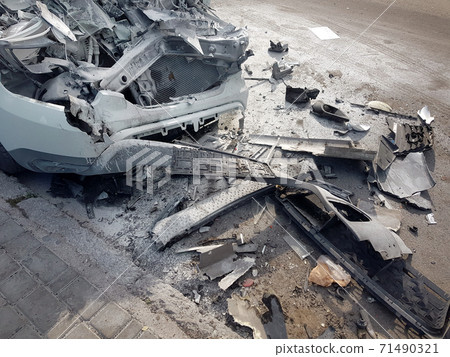 front of a car destroyed by an accident and covered with a layer of white foam after extinguishing a car in a disaster, close-up of the damaged parts after a head-on collision. 71490321