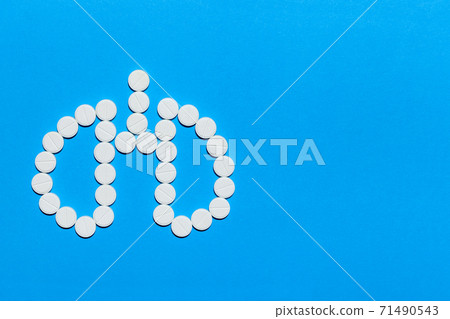 lungs symbol made of white round pills on a blue background with copy space. lungs symbol made of white round pills on a blue background with copy space. 71490543