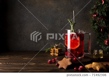 cranberry juice with lemon honey and cinnamon in a glass mug 71492306