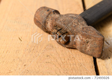 Old vintage hammer closeup on a wooden background, household hand tools 71493026