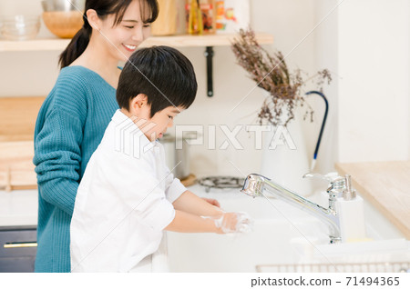 Boy washing hands with his mother Boy washing hands with his mother 71494365