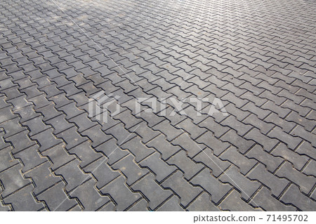 paving slabs of gray color pedestrian square paved with stone, closeup of empty space. 71495702