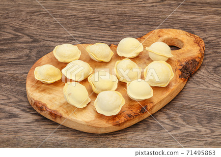 Raw dumplings over board for cooking Raw dumplings over board for cooking 71495863