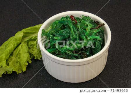 Green Chuka Seaweed Salad Isolated on White Background Top View. Wakame Sea Kelp Salat 71495953
