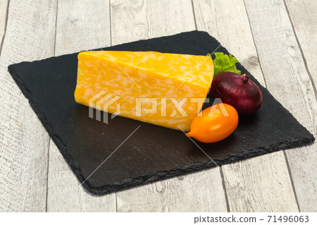 Marble cheese triangle over wooden Marble cheese triangle over wooden 71496063