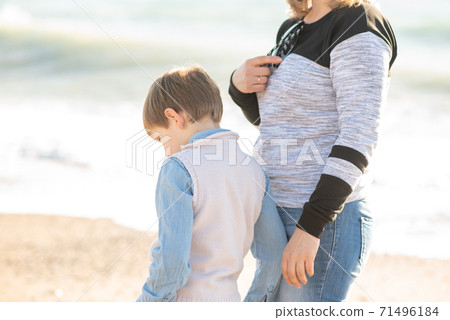 Mom and baby boy on the beach. Mom and baby boy on the beach. 71496184
