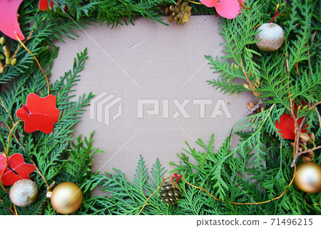 Fir branches, decorated with Christmas decorations lie on a cardboard background with copy space 71496215