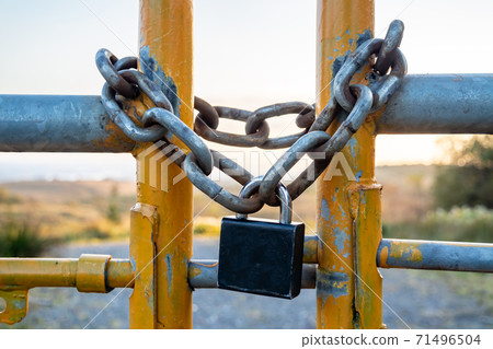 Padlock and chain at gate in wild Ireland Padlock and chain at gate in wild Ireland 71496504
