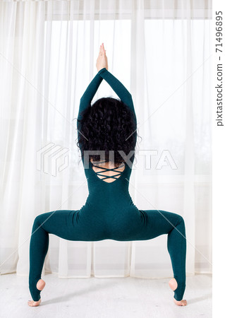 alone girl in sportswear doing yoga exercises on the floor in the light room during quarantine of covid 19 cotonavirus stay home safe world. 71496895