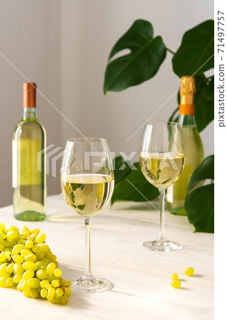 Two glasses with white wine and a bottle Two glasses with white wine and a bottle 71497757