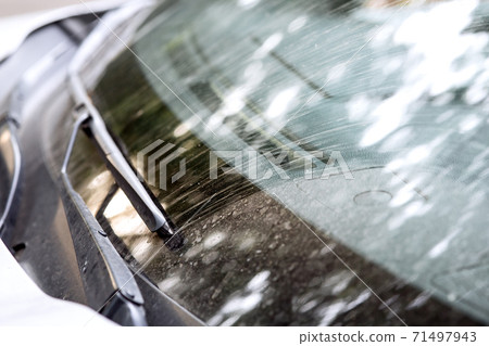 windshield with wipers of a dirty car in dust and smeared with swamp close up. 71497943
