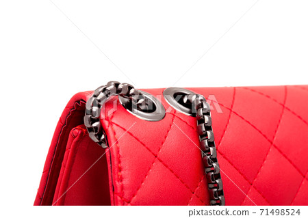 woman`s handbag with red leather square pattern and metal strap, side view close up details. 71498524