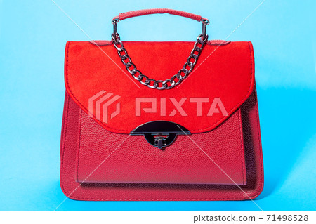 women's handbag in red leather and suede, object on a blue background. women's handbag in red leather and suede, object on a blue background. 71498528