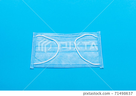 protective medical face mask, object of health care and protection against the virus on a blue background. 71498637