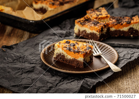 Delicious pumpkin cake with cheese cream and cacao or chocolate on the top 71500027