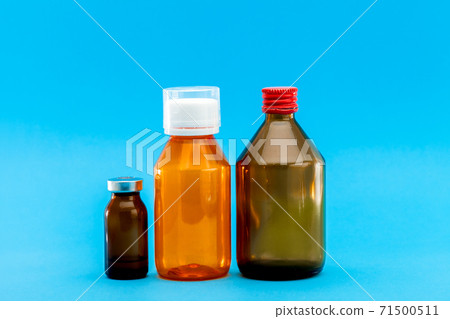 jar with medical disinfectants and a glass bottle for health treatment, pharmacy objects on a blue background with a copy space. jar with medical disinfectants and a glass bottle for health treatment, pharmacy objects on a blue background with a copy space. 71500511