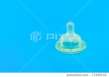 silicone pacifier for baby feeding bottle, baby health care object isolated on blue background with copy space, nobody. silicone pacifier for baby feeding bottle, baby health care object isolated on blue background with copy space, nobody. 71500516