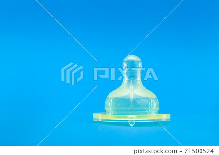 silicone pacifier on baby feeding bottle, baby health care object isolated on blue background with copy space, nobody. silicone pacifier on baby feeding bottle, baby health care object isolated on blue background with copy space, nobody. 71500524