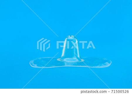 Contact nipple shield nippleshield for breastfeeding with latch difficulties or flat or inverted nipples, silicone nipple protectors isolated on blue background with copy space. Contact nipple shield nippleshield for breastfeeding with latch difficulties or flat or inverted nipples, silicone nipple protectors isolated on blue background with copy space. 71500526