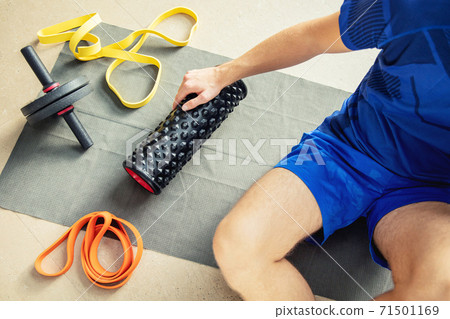 Top view of young man's arm holding exercise machine Top view of young man's arm holding exercise machine 71501169