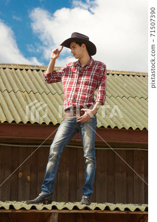 Young romantic cowboy is on the roof 71507390