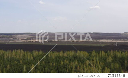 Aerial survey of arable land. Plowed field. Fertile land of arable land. Sowing. Fly over the arable land. 71513846