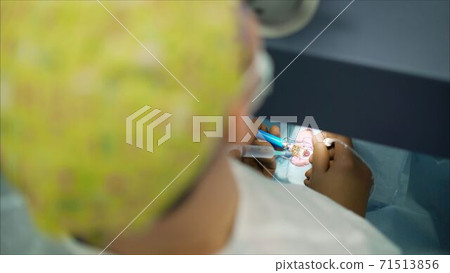 ophthalmology operation. Surgeon's hands in gloves performing laser eye vision correction correction 71513856