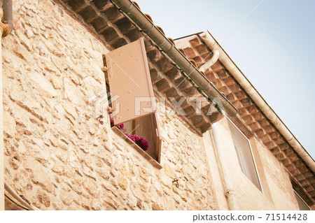 High window with open shutters in yellow brick wall High window with open shutters in yellow brick wall 71514428