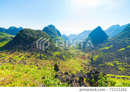 Ha Giang karst geopark mountain landscape in North Vietnam. Winding road in stunning scenery. Ha Giang motorbike loop, famous travel destination bikers easy riders. Ha Giang karst geopark mountain landscape in North Vietnam. Winding road in stunning scenery. Ha Giang motorbike loop, famous travel destination bikers easy riders. 71515262