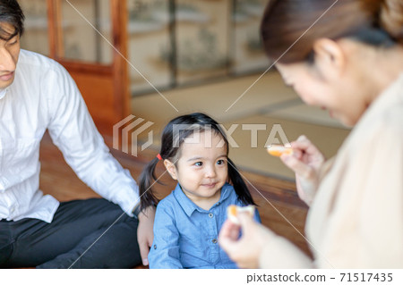 Toddler eating oranges on the porch of an old folk house Toddler eating oranges on the porch of an old folk house 71517435