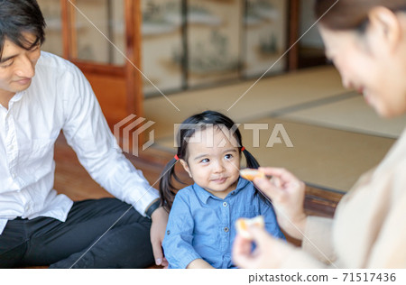 Toddler eating oranges on the porch of an old folk house Toddler eating oranges on the porch of an old folk house 71517436