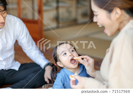 Toddler eating oranges on the porch of an old folk house Toddler eating oranges on the porch of an old folk house 71517569