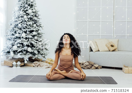 Beautiful young woman practices yoga asana Virabhadrasana at the yoga class. 71518324
