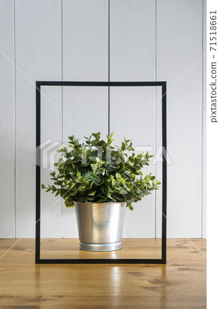 A blank black frame  and a flowerpot 71518661